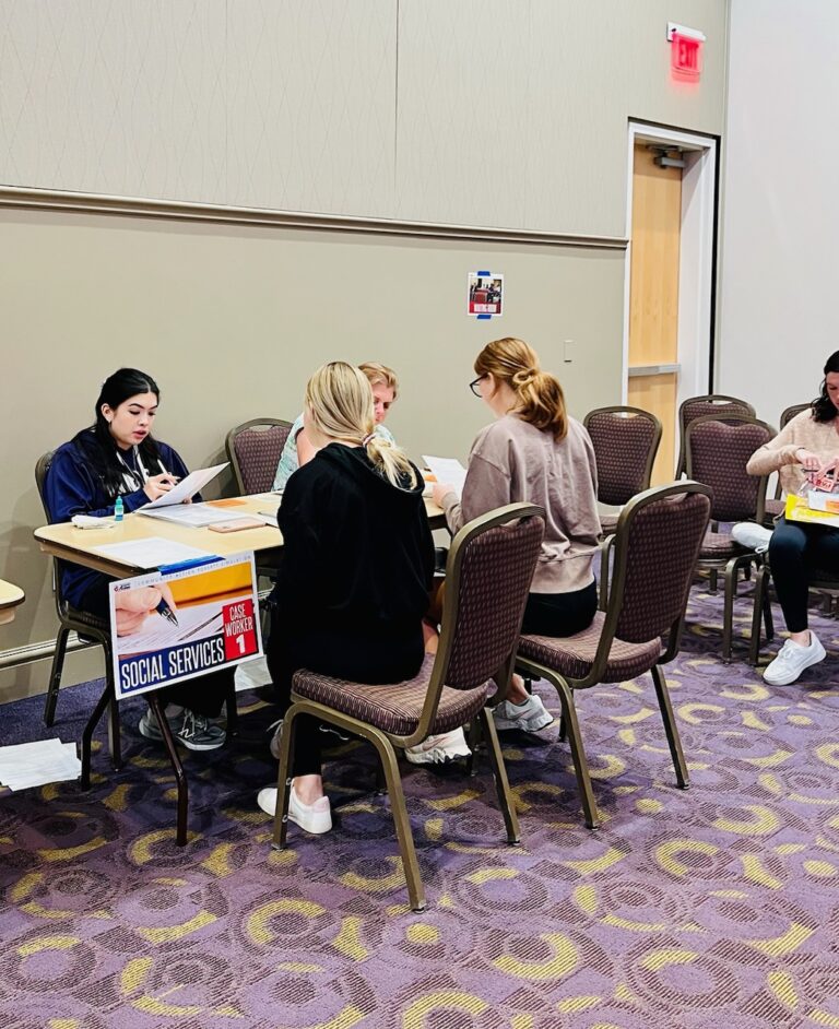 Faculty and students participate in the 2022 Harris College poverty simulation.